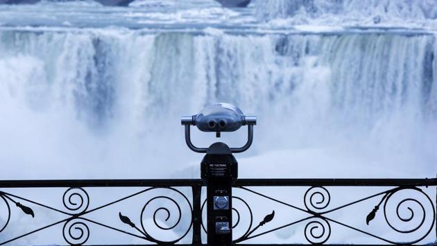 Binoculars look over ice forming at the base of the American Falls as viewed from Ontario. Much of the eastern United States is gripped by a sustained cold spell that has played havoc with public works causing pipes to freeze and water mains to burst, and impeded firefighting as temperatures barely crossed -6 degrees Celcius. (Aaron Lynett / The Canadian Press via AP) Binoculars look over ice forming at the base of the American Falls as viewed from Ontario. Much of the eastern United States is gripped by a sustained cold spell that has played havoc with public works causing pipes to freeze and water mains to burst, and impeded firefighting as temperatures barely crossed -6 degrees Celcius. (Aaron Lynett / The Canadian Press via AP)
