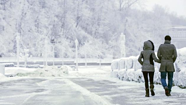 A couple walks near the brink of the Horseshoe Falls in Ontario. With the arctic air mass expected entrenched over the eastern two-thirds of the US through the weekend, New York braces for several inches of snow and severe gusts adding to the chill. (Aaron Lynett / The Canadian Press via AP) A couple walks near the brink of the Horseshoe Falls in Ontario. With the arctic air mass expected entrenched over the eastern two-thirds of the US through the weekend, New York braces for several inches of snow and severe gusts adding to the chill. (Aaron Lynett / The Canadian Press via AP)