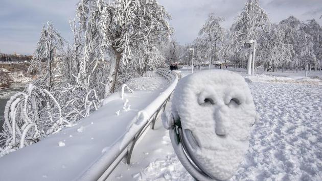 A coin operated binocular is covered with snow on Goat Island, New York. The cold, coupled with icy winds of nearly 65 kmph forces visitors to pause for a warming break midway from the parking lot to the water’s edge. (James Neiss / The Niagara Gazette via AP) A coin operated binocular is covered with snow on Goat Island, New York. The cold, coupled with icy winds of nearly 65 kmph forces visitors to pause for a warming break midway from the parking lot to the water’s edge. (James Neiss / The Niagara Gazette via AP)
