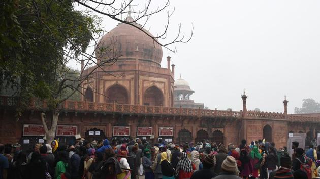 Visitors gather at the ticket office of the Taj Mahal in Agra on January 3, 2018. The Archaeological Survey of India is likely to restrict the number of tourists visiting the Taj Mahal to 40,000 daily, and put a three-hour cap on each ticket holder, in a bid to preserve the heritage site. (Dominique Faget / AFP)