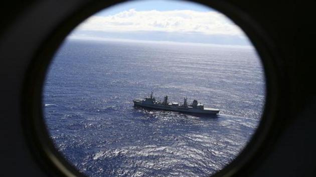 In this March 31, 2014 file photo, HMAS Success scans the southern Indian Ocean, near the coast of Western Australia, as a Royal New Zealand Air Force P3 Orion flies over, while searching for missing Malaysia Airlines Flight MH370.(AP Photo)