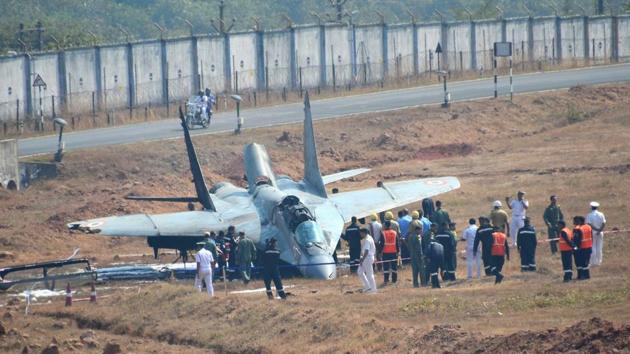 Security personnel standing near the MiG-29 K aircraft of the navy which caught fire after it skidded off the runway in Goa’s Dabolim International Airport on Wednesday. (PTI)