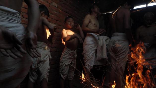 Nepalese devotees warm themselves before a dip in the Hanumante River during the Madhav Narayan Festival in Bhaktapur. This religious festival is also known as the Swasthani Brata Katha festival. (Niranjan Shrestha / AP) Nepalese devotees warm themselves before a dip in the Hanumante River during the Madhav Narayan Festival in Bhaktapur. This religious festival is also known as the Swasthani Brata Katha festival. (Niranjan Shrestha / AP)