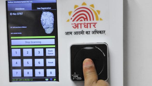 Employees mark their attendance through Aadhaar in the Planning Commission in New Delhi.(HT file)