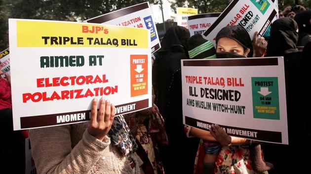 Muslim women hold placards during a protest against a bill passed by the Lok Sabha last week that aims at prosecuting Muslim men who divorce their wives through triple talaq.(Reuters)