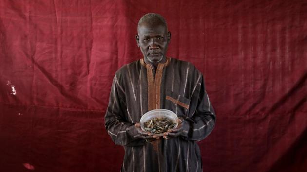 Abdulwahal Abdulla, a 50-year-old living in Bakasi for three years, hoped to trade his bowl of young tilapia worth roughly 150 naira for cooking oil. The dusty Bakasi camp sits on the outskirts of the city of Maiduguri in Borno, the spiritual home of the Islamist Boko Haram movement, which wants to establish a caliphate in the region surrounding Lake Chad. (Afolabi Sotunde / REUTERS) Abdulwahal Abdulla, a 50-year-old living in Bakasi for three years, hoped to trade his bowl of young tilapia worth roughly 150 naira for cooking oil. The dusty Bakasi camp sits on the outskirts of the city of Maiduguri in Borno, the spiritual home of the Islamist Boko Haram movement, which wants to establish a caliphate in the region surrounding Lake Chad. (Afolabi Sotunde / REUTERS)