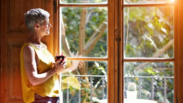 Shot of a mature woman standing by a window at home drinking a cup of coffee(Getty Images) Shot of a mature woman standing by a window at home drinking a cup of coffee(Getty Images)