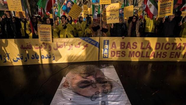 Protesters in Paris on Wednesday hold placards as they stand behind a portrait of Iranian President Hassan Rouhani during a demonstration in support of the Iranian people amid a wave of protests spreading throughout the country. (AFP) Protesters in Paris on Wednesday hold placards as they stand behind a portrait of Iranian President Hassan Rouhani during a demonstration in support of the Iranian people amid a wave of protests spreading throughout the country. (AFP)