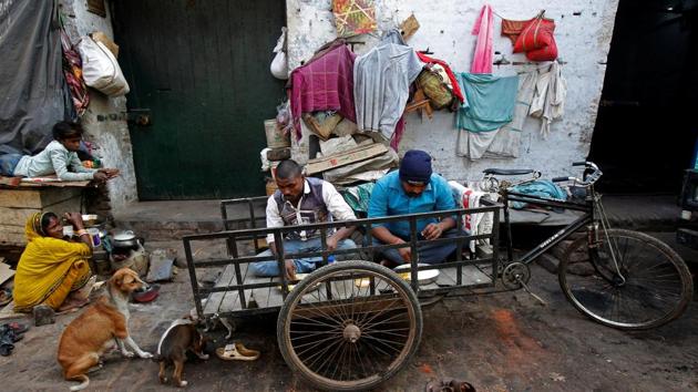 Tricycle pullers eat food at their makeshift home in Kolkata, on Thursday. (Reuters) Tricycle pullers eat food at their makeshift home in Kolkata, on Thursday. (Reuters)