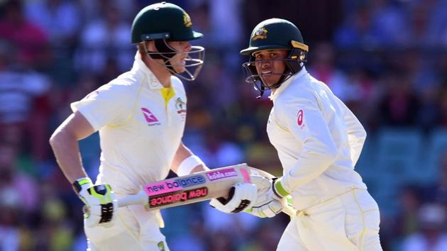 Australia's Steve Smith (L) and Usman Khawaja take runs on Day 2 of the fifth Ashes Test in Sydney. (AFP)