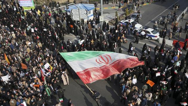 A demonstrator waves a huge Iranian flag during a pro-government rally in the northeastern city of Mashhad on Thursday. (AP) A demonstrator waves a huge Iranian flag during a pro-government rally in the northeastern city of Mashhad on Thursday. (AP)