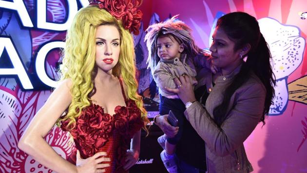 People pose alongside a wax figure of Lady Gaga. Apart from rubbing shoulders with their favourite celebrities for some amazing photo opportunities, guests can also partake in exciting activities and buy special merchandise at the attraction. (Sanchit Khanna / HT Photo)