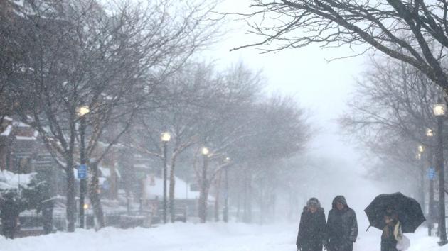Pedestrians walk down a vacant Newbury Street during a massive winter storm in Boston, Massachusetts. (AFP)