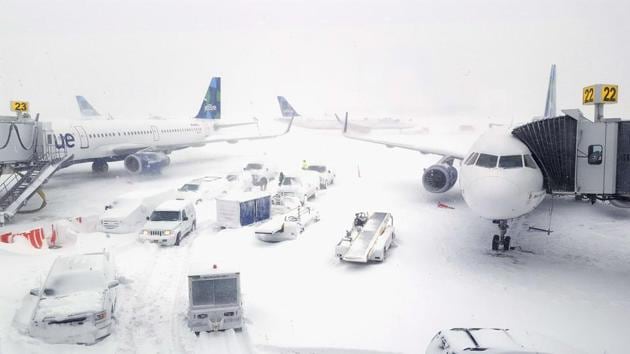JetBlue airplanes wait at the gates outside terminal five at John F Kennedy International Airport on Thursday in the Queens borough of New York City. (AFP)
