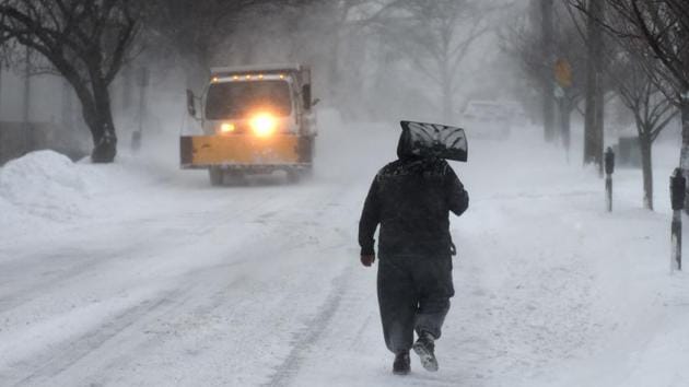 A man carries a shovel up the middle of the street in Greenwich, Connecticut on January 4, 2018. (AFP Photo) A man carries a shovel up the middle of the street in Greenwich, Connecticut on January 4, 2018. (AFP Photo)