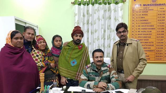 Bhagabangola police station officer-in-charge Uptal Das (seated) with Mohammad Jafar (in shawl) and his family members. (HT Photo) Bhagabangola police station officer-in-charge Uptal Das (seated) with Mohammad Jafar (in shawl) and his family members. (HT Photo)