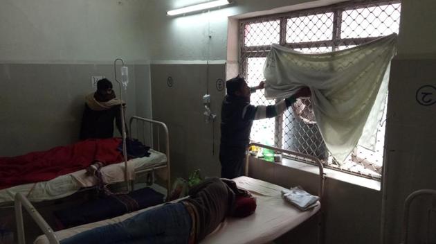 As the icy wind enters through the open windows, attendants put up plastic sheets and even bed sheets for cover. (HT Photo) As the icy wind enters through the open windows, attendants put up plastic sheets and even bed sheets for cover. (HT Photo)