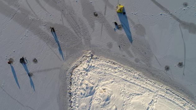 An aerial view shows men fishing on thin ice covering the Yenisei River, with the air temperature at about minus 25 degrees Celsius, on January 02, 2018 in Krasnoyarsk, Russia. (Ilya Naymushin / REUTERS) An aerial view shows men fishing on thin ice covering the Yenisei River, with the air temperature at about minus 25 degrees Celsius, on January 02, 2018 in Krasnoyarsk, Russia. (Ilya Naymushin / REUTERS)