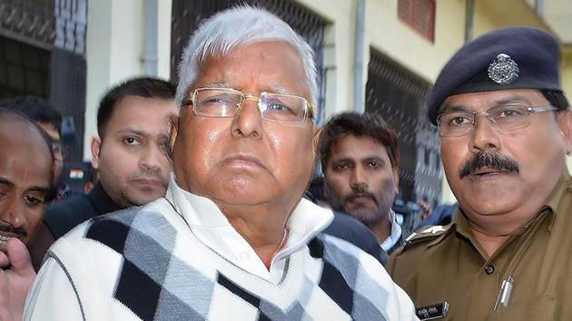 Rashtriya Janata Dal chief Lalu Prasad Yadav escorted by police officials after being convicted by the special CBI court in fodder scam case, in Ranchi in December 2017. (PTI File Photo) Rashtriya Janata Dal chief Lalu Prasad Yadav escorted by police officials after being convicted by the special CBI court in fodder scam case, in Ranchi in December 2017. (PTI File Photo)