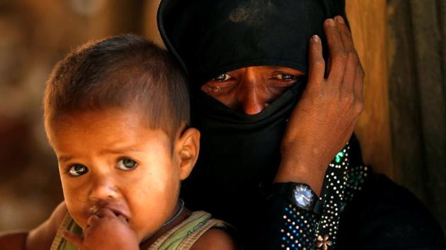 A Rohingya refugee cries next to her son, outside a temporary mosque at Kutupalong refugee camp on January 04 2018 near Cox's Bazar, Bangladesh. (Tyrone Siu / REUTERS) A Rohingya refugee cries next to her son, outside a temporary mosque at Kutupalong refugee camp on January 04 2018 near Cox's Bazar, Bangladesh. (Tyrone Siu / REUTERS)
