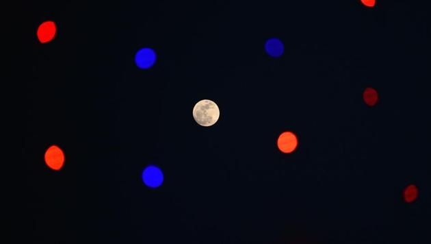 A 'supermoon' rises on the sky next to decorative lights in Jalandhar. (Shammi Mehra / AFP) A 'supermoon' rises on the sky next to decorative lights in Jalandhar. (Shammi Mehra / AFP)
