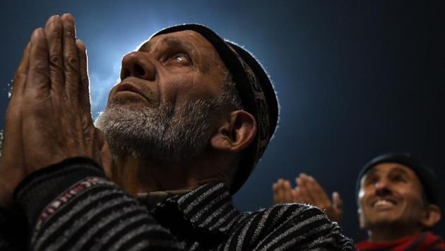 Kashmiris offer prayers as a priest displays a relic at the shrine of Sheikh Abdul Qadir Geelani in Srinagar. (Tauseef Mustafa / AFP) Kashmiris offer prayers as a priest displays a relic at the shrine of Sheikh Abdul Qadir Geelani in Srinagar. (Tauseef Mustafa / AFP)