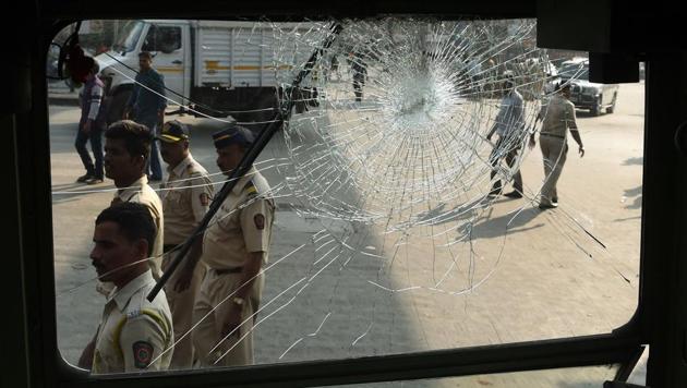 Indian policemen walk past the broken window of a bus after a Republican Party of India (RPI) protest turned violent in Mumbai. India's Republican Party supporters turned violent during a protest on January 2, a day after the death of young Dalit activist in Maharashtra's Pune district following an altercation between two groups during celebrations to mark the bicentenary of a British-Peshwa war. (Punit Paranjpe / AFP) Indian policemen walk past the broken window of a bus after a Republican Party of India (RPI) protest turned violent in Mumbai. India's Republican Party supporters turned violent during a protest on January 2, a day after the death of young Dalit activist in Maharashtra's Pune district following an altercation between two groups during celebrations to mark the bicentenary of a British-Peshwa war. (Punit Paranjpe / AFP)