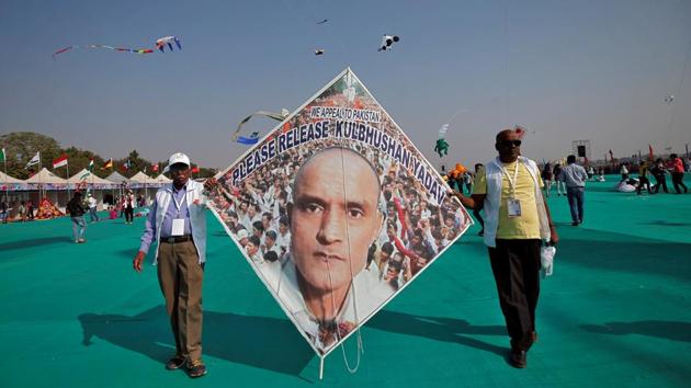 Kite-flying enthusiasts hold up a kite with an image of Kulbhushan Sudhir Jadhav, a former officer in the Indian Navy, who was arrested in March 2016 in the Pakistani province of Baluchistan, at the festival. Besides Ahmedabad, the festival will also be celebrated in other cities in the state, including Jamnagar, Surat, Dwarka, Rajkot, Vadodara and Gandhidham. (Amit Dave / REUTERS)