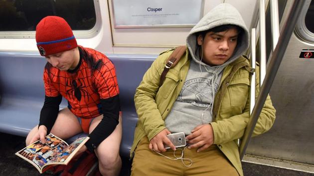 A participant reads a comic book during the 17th No Pants Subway Ride in the New York City subway. Recent No Pants rides have drawn nearly 4,000 participants in New York, with thousands participating globally.  (Timothy A. Clary / AFP) 