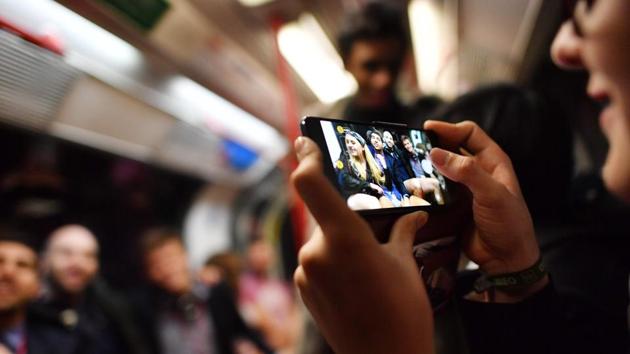 A commuter takes a picture of people as they take part in the annual No Trousers On The Tube Day (No Pants Subway Ride) on the Central line in London. Aimed as light-hearted fun, the event has drawn attention specifically in 2006, when 8 people were handcuffed and arrested by police for disorderly conduct on the subway. (Ben Stansall / AFP) 