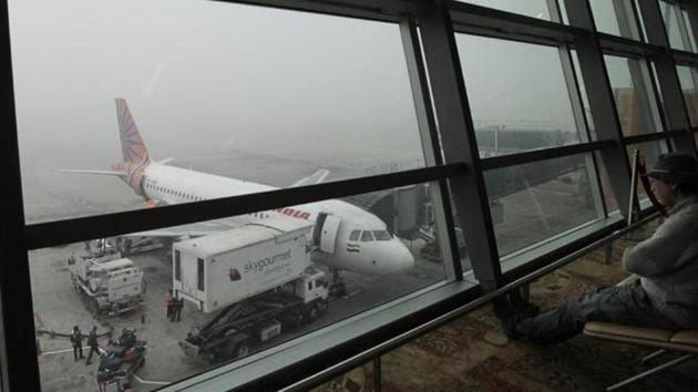 A passenger looks on as an aircraft awaits departure during fog at the T3 of Indira Gandhi International Airport in New Delhi, India. (HT File Photo) A passenger looks on as an aircraft awaits departure during fog at the T3 of Indira Gandhi International Airport in New Delhi, India. (HT File Photo)