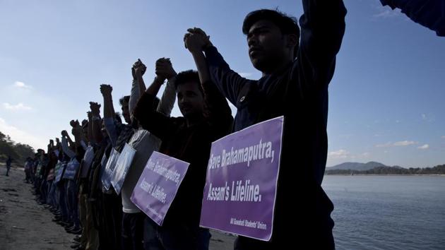 Students from Assam hold hands by the Brahmaputra river during a protest against the contamination of the river in Guwahati on December 11, 2017. Officials in India's northeast are complaining that Chinese construction activity on the upper reaches of one of the largest rivers that flows into India are likely turning the waters downstream turbid and unfit for human consumption. (AP Photo/Anupam Nath)(AP) Students from Assam hold hands by the Brahmaputra river during a protest against the contamination of the river in Guwahati on December 11, 2017. Officials in India's northeast are complaining that Chinese construction activity on the upper reaches of one of the largest rivers that flows into India are likely turning the waters downstream turbid and unfit for human consumption. (AP Photo/Anupam Nath)(AP)