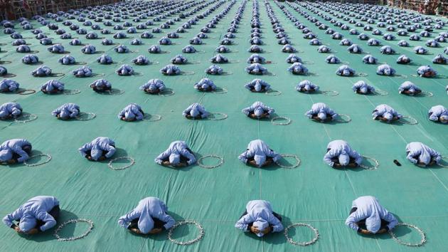 School children perform yoga during the inauguration ceremony of the festival. Organised to mark the approaching end of winter on Makar Sankranti --as the sun leaves the month of the winter solstice-- kite-enthusiasts throng to the city’s markets the night prior to purchase supplies for fierce mid-air competitions. (Ajit Solanki / AP)
