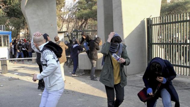 University students run away from stones thrown by the police during an anti-government protest inside Tehran University. Demonstrations, the largest seen in Iran since its disputed 2009 presidential election, have brought six days of unrest across the country and resulted in over 20 deaths. (AP) University students run away from stones thrown by the police during an anti-government protest inside Tehran University. Demonstrations, the largest seen in Iran since its disputed 2009 presidential election, have brought six days of unrest across the country and resulted in over 20 deaths. (AP)