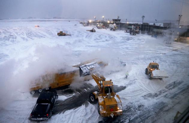 Front loaders dump snow into a melter while clearing the apron around Gates C and D at Terminal B at LaGuardia Airport, Thursday, Jan. 4, 2018, in New York. All flights have been suspended temporarily at JFK and LaGuardia airports due to wind and whiteout conditions. (AP Photo/Julie Jacobson) (AP) Front loaders dump snow into a melter while clearing the apron around Gates C and D at Terminal B at LaGuardia Airport, Thursday, Jan. 4, 2018, in New York. All flights have been suspended temporarily at JFK and LaGuardia airports due to wind and whiteout conditions. (AP Photo/Julie Jacobson) (AP)
