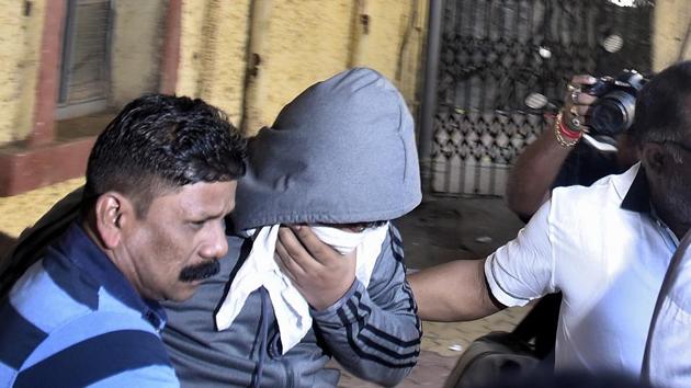The Mojo Bistro co-owner Yug Phatak (face covered) outside a Mumbai court on Sunday. (Anshuman Poyrekar/HT Photo) The Mojo Bistro co-owner Yug Phatak (face covered) outside a Mumbai court on Sunday. (Anshuman Poyrekar/HT Photo)