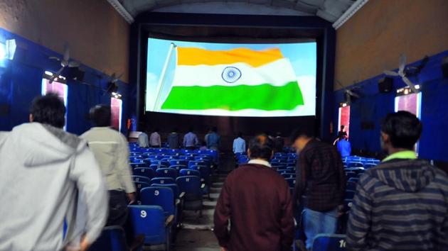 People stand up for the national anthem before the start of a movie at a theatre in Indore.(HT Photo)