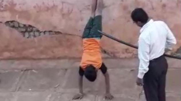 A hostel warden forced two teenagers to perform handstands as punishment.(Video screengrab)