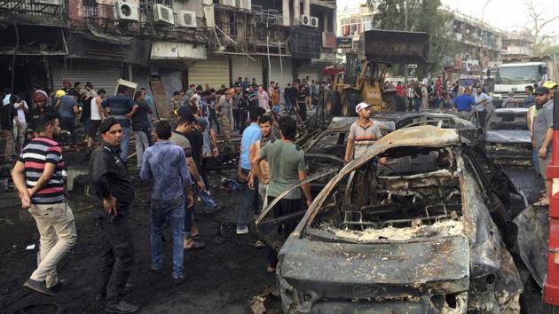 raqi security forces and civilians gather at the site after a car bomb at a commercial area in Karada neighborhood, Baghdad, Iraq, Sunday, July 3, 2016. Bombs went off early Sunday in two crowded commercial areas in Baghdad. (AP File Photo) raqi security forces and civilians gather at the site after a car bomb at a commercial area in Karada neighborhood, Baghdad, Iraq, Sunday, July 3, 2016. Bombs went off early Sunday in two crowded commercial areas in Baghdad. (AP File Photo)