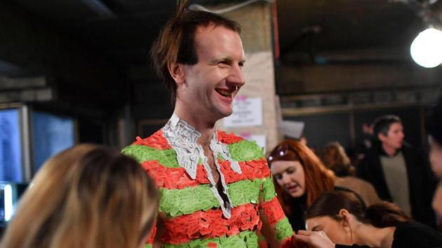 A model gets prepared backstage with an outfit made of price tags ahead of the MAN collection catwalk show on the third day of the Autumn/Winter 2018 London Fashion Week Men's, in London on January 7, 2018. (AFP) A model gets prepared backstage with an outfit made of price tags ahead of the MAN collection catwalk show on the third day of the Autumn/Winter 2018 London Fashion Week Men's, in London on January 7, 2018. (AFP)