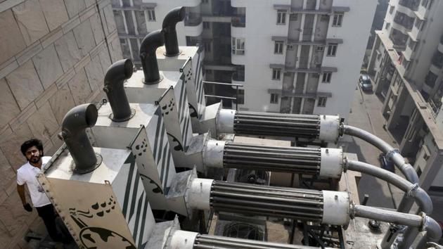 Dhupar was inspired by a diesel generator that was powering a roadside juice stall and turning the wall behind it black in the process. “What would have otherwise been a waste is captured and reborn to be used as a raw material again,” he said, adding that in 18 months, the machines had collected enough carbon to pollute about 1.5 billion litres of air. (Money Sharma / AFP) 
