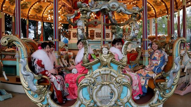 Women ride a merry-go-round during Coming of Age Day celebrations. There were an estimated 1.23 million new adults as of January 1 -- largely unchanged from the previous year, and half the 1970 peak of 2.46 million, according to government figures. (Kim Kyung-Hoon / REUTERS) Women ride a merry-go-round during Coming of Age Day celebrations. There were an estimated 1.23 million new adults as of January 1 -- largely unchanged from the previous year, and half the 1970 peak of 2.46 million, according to government figures. (Kim Kyung-Hoon / REUTERS)