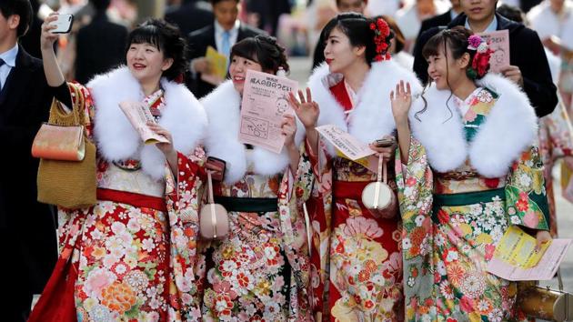 Women pose for photos as they arrive to attend a formal ceremony in Tokyo. The stagnant numbers are partially blamed on Japan’s shrinking population and also on reluctance among young adults who consider age simply a number and choose instead to enter adulthood without fanfare. (Kim Kyung-Hoon / REUTERS) Women pose for photos as they arrive to attend a formal ceremony in Tokyo. The stagnant numbers are partially blamed on Japan’s shrinking population and also on reluctance among young adults who consider age simply a number and choose instead to enter adulthood without fanfare. (Kim Kyung-Hoon / REUTERS)