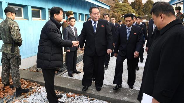 Head of North Korean delegation Ri Son Gwon, Chairman of the Committee for the Peaceful Reunification of the Country (CPRC) of DPRK, shakes hands with South Korean official as he crosses the concrete border to attend their meeting at the truce village of Panmunjom in the demilitarised zone separating the two Koreas, South Korea, January 9, 2018. (REUTERS Photo) Head of North Korean delegation Ri Son Gwon, Chairman of the Committee for the Peaceful Reunification of the Country (CPRC) of DPRK, shakes hands with South Korean official as he crosses the concrete border to attend their meeting at the truce village of Panmunjom in the demilitarised zone separating the two Koreas, South Korea, January 9, 2018. (REUTERS Photo)