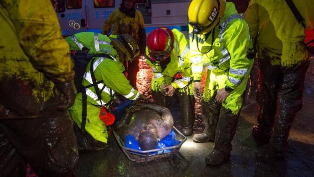 Emergency personnel carry a man covered in mud after a mudslide in Montecito. The county set up an evacuation shelter at Santa Barbara City College, where people showed up drenched in mud, and also provided a place for people to take their animals. (Kenneth Song / Santa Barbara News-Press / REUTERS) 