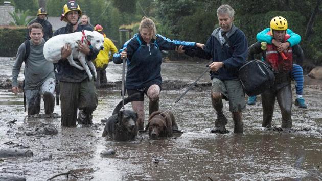 Emergency workers using search dogs and helicopters rescued dozens of people stranded in mud-coated rubble in the normally pristine area, sandwiched between the ocean and the sprawling Los Padres National Forest. Heavy downpours struck before dawn on Tuesday after thousands of residents in Santa Barbara County along the Pacific coast north of Los Angeles were ordered to evacuate or urged to do so voluntarily. (Kenneth Song / Santa Barbara News-Press / REUTERS) 