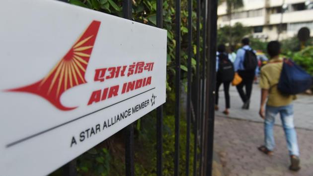 Pedestrians walk past a sign of state carrier Air India outside its headquarters in Mumbai. The state carrier will be opened up for investment by foreign companies, the government decided on January 10. (AFP) Pedestrians walk past a sign of state carrier Air India outside its headquarters in Mumbai. The state carrier will be opened up for investment by foreign companies, the government decided on January 10. (AFP)