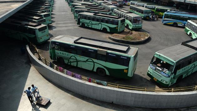 Travellers stand next to buses parked at a depot during a transport strike in Chennai on January 5. (AFP File Photo) Travellers stand next to buses parked at a depot during a transport strike in Chennai on January 5. (AFP File Photo)