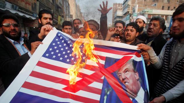 People burn a sign depicting a US flag and a picture of US President Donald Trump as they take part in an anti-America rally in Peshawar, on January 5, 2018. (Reuters file) People burn a sign depicting a US flag and a picture of US President Donald Trump as they take part in an anti-America rally in Peshawar, on January 5, 2018. (Reuters file)