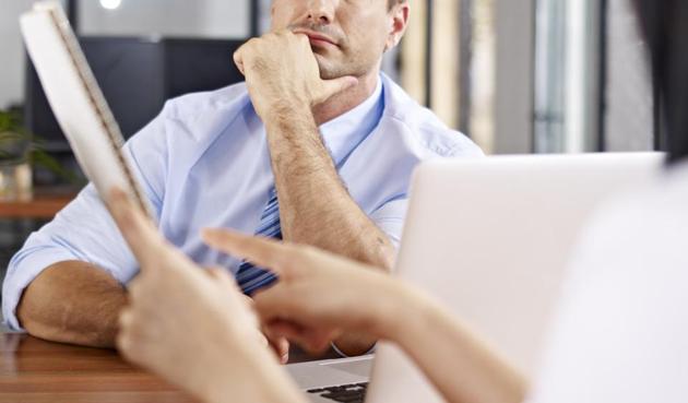 a caucasian male interviewer looking skeptical while listening to an asian female interviewee. (Getty Images/iStockphoto) a caucasian male interviewer looking skeptical while listening to an asian female interviewee. (Getty Images/iStockphoto)